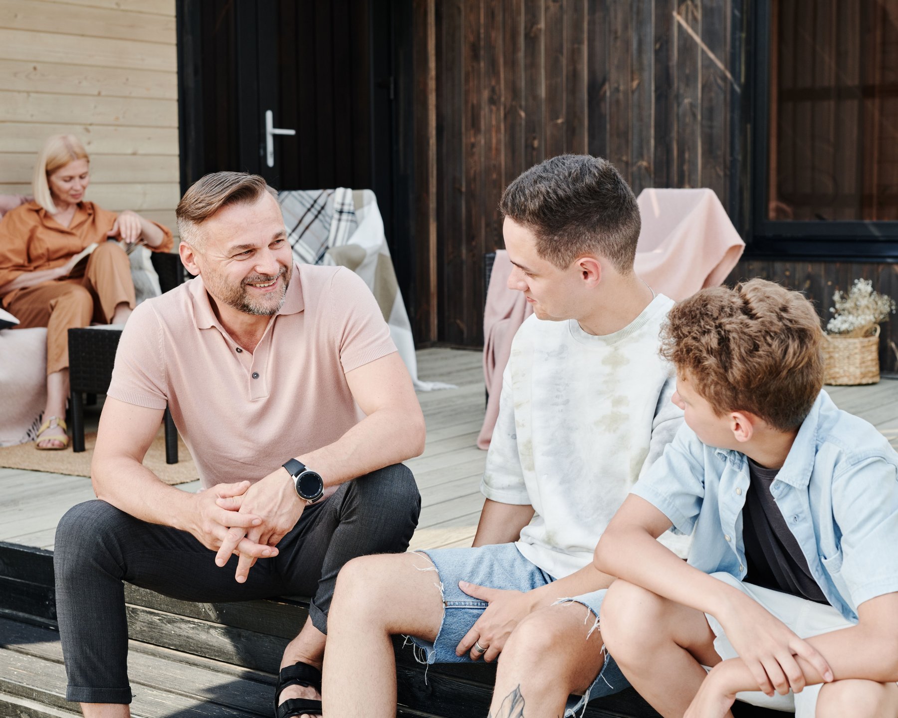 A father having a warm conversation with his two sons outdoors